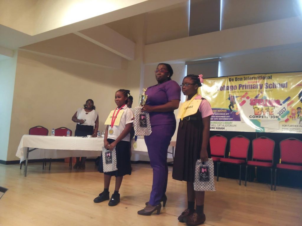 Christa Williams, left, second place winner in the Juniors category of the De Don International (Donnie Stewart) first Spelling Bee competition, stand with Dijonne Phillips, third place winner and a teacher at the finals on Monday.