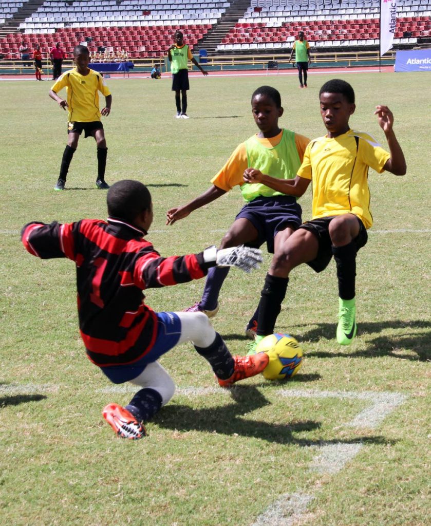 Eastern Boys’ goalkeeper, Abdullah Noel makes a tremendous save from a shot by La Pastora player Jadiel Joseph,right during the teams’ U12 match in the Atlantic Primary Schools’ League finals at Hasely Crawford Stadium yesterday. La Pastora won 2-0.