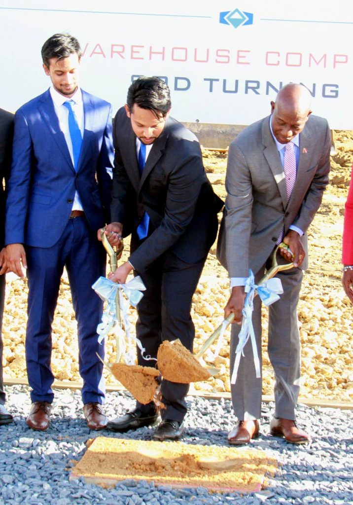 BREAKING GROUND: Prime Minister Dr Keith Rowley (right) and executive director of Edan K Properties Limited, Nyal Khan, turn the sod for the Point Lisas business park project at Brechin Castle, Couva yesterday.