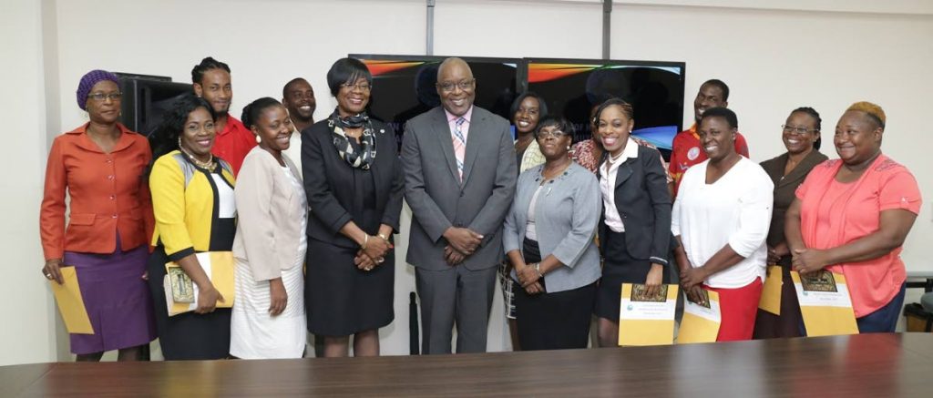 Recipients of grants from the REACH programme pose for a photo with Chief Secretary Kelvin Charles, third from left, front row, Health Secretary Agatha Carrington, second from left, front row, Marisha Osmond, left, front row, Assistant Secretary in the Office of the Chief Secretary, and Karen Ottley, Administrator in the Division of Health at a grant distribution ceremony on Tuesday at the Division of Health, Glen Road.