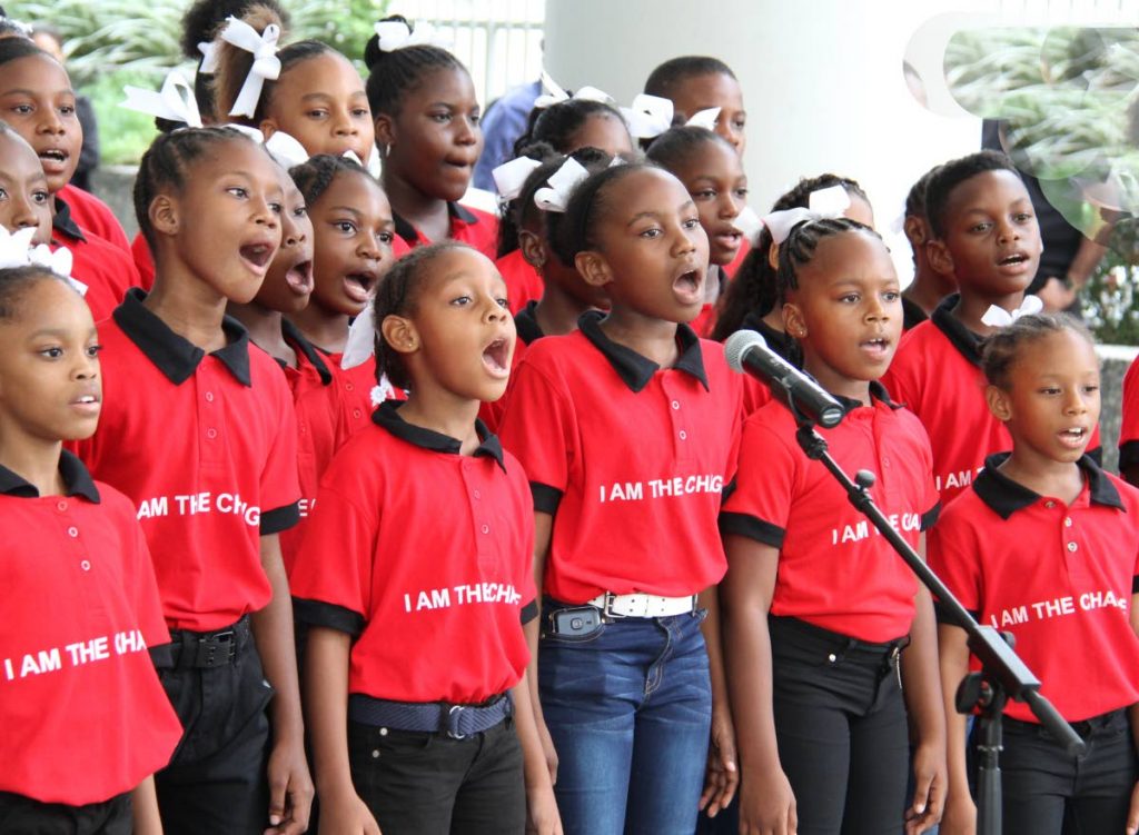 JOYFUL VOICES: Students of the Gloster Lodge Moravian school sing Christmas carols yesterday at the lobby of the Education Ministry in Port of Spain. PHOTO BY SUREASH CHOLAI