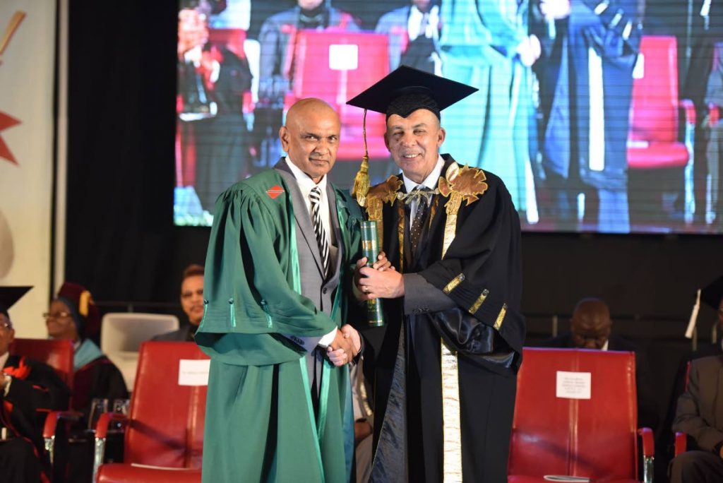 Amerish Gagedeen (left) receiving his degree from Chancellor of the University of Trinidad and Tobago, President Anthony Carmona.