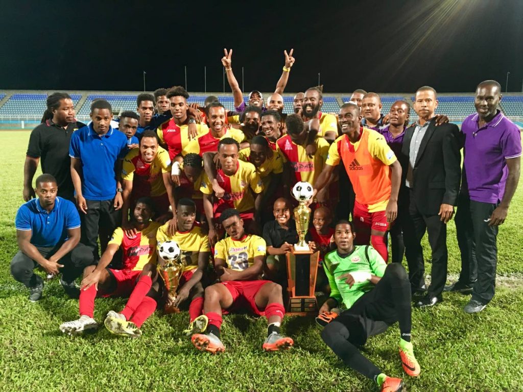 North East Stars players, coach and owner celebrate their 2nd Pro League title on 
Friday night along TT Pro League CEO Dexter Skeene, second from right, after beating 
Police FC at the Ato Boldon Stadium, Couva.