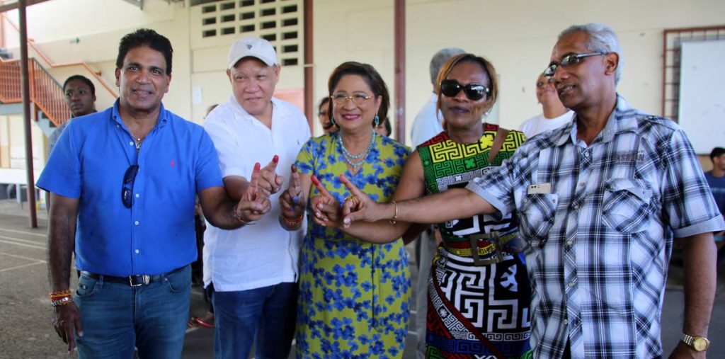 UNITED FRONT: Opposition Leader Kamla Persad-Bissessar (centre) shows off her index finger shortly after voting, at the Parvati Girls Hindu College in Debe yesterday, in the United National Congress’ internal election.  With her, from left, are Oropouche East MP Dr Roodal Moonilal, new deputy political leaders David Lee and Jearlean John and new chairman Peter Kanhai.
