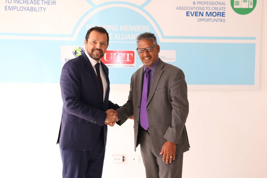 (L to R) Nestlé's Head of Market and Food Production, Patricio Torres, meets Food Production Minister Clarence Rambharat. PHOTO COURTESY NESTLÉ.