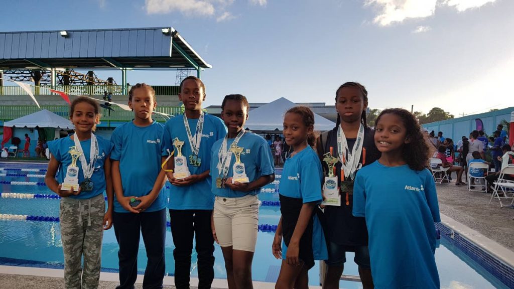 (From left) Jacob Cox, Theo Bicknell-Roberts, Timothy Clarke, Abrisse Trim, Tamia Peterkin, Jaylon Campbell and Tiana Peterkin pose after a strong showing at the Atlantic Schools Invitational Swim Meet recently.