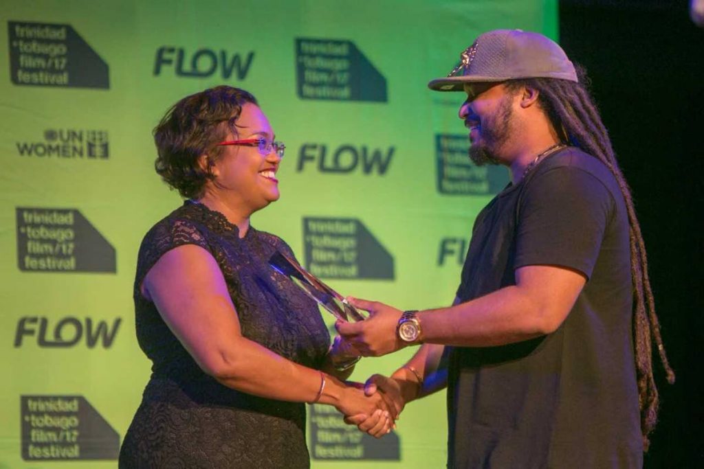 Cindy Ann Galt presents award to Green Days By the River director Michael Mooledhar during the Trinidad and Tobago Film Festival in September.