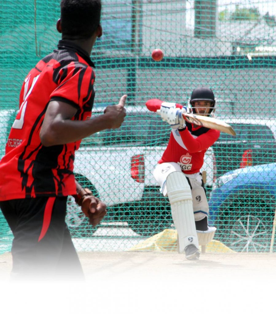 Red Force batsman Amir Jangoo hits a shot during a training session last month at the Queen’s Park Oval, St Clair.