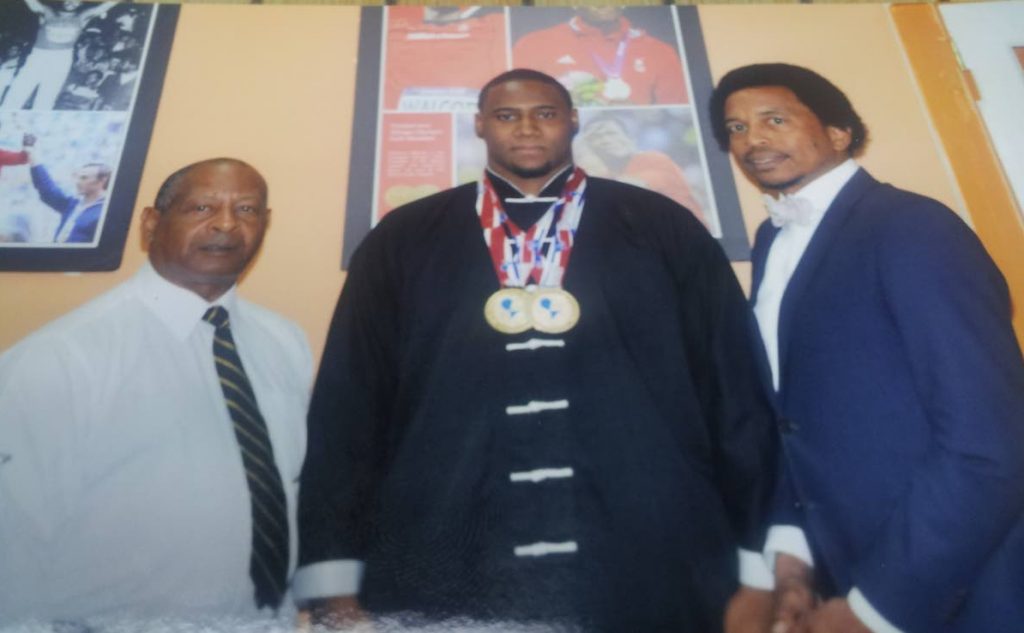 Stefan O’Neil, centre, along with president of the Wushu Association  of TT Rahman Khabir, left, and president of the TT Olympic Committee Brian Lewis.