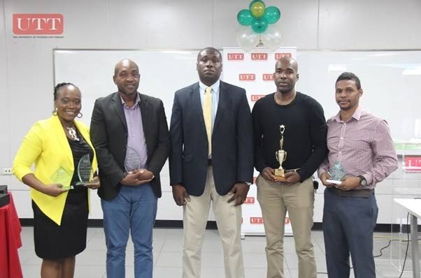 Programme Leader Kerry Dollaway (centre) poses with some of the Masters awardees, including Newsday’s freelance sports journalist Sherdon Pierre (right).