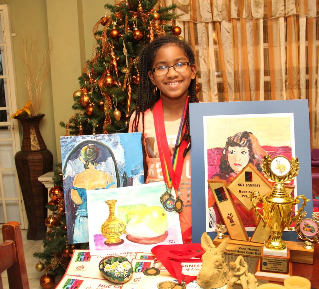 BIG WINNER: Zara Thomas with some of her paintings and awards.