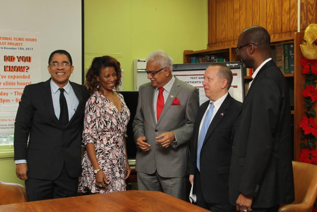 CARE: Health Minister Terrence Deyalsingh (centre) is flanked by members of the HIV/AIDS medical outreach team at the Medical Research Foundation yesterday. PHOTO BY RATTAN JADOO