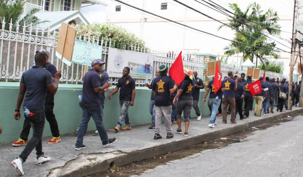 Members of the OWTU protest outside JSL International Ltd on Abercromby Street in Port Of Spain over the treatment of workers.