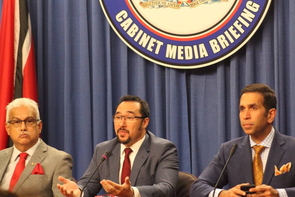 MINISTER in the Office of the Prime Minister, Stuart Young, centre, makes a point at yesterday’s post-Cabinet news briefing at the Diplomatc Centre, St Ann’s, flanked by Health Minister Terrence Deyalsingh, left, and Attorney General Faris Al-Rawi.