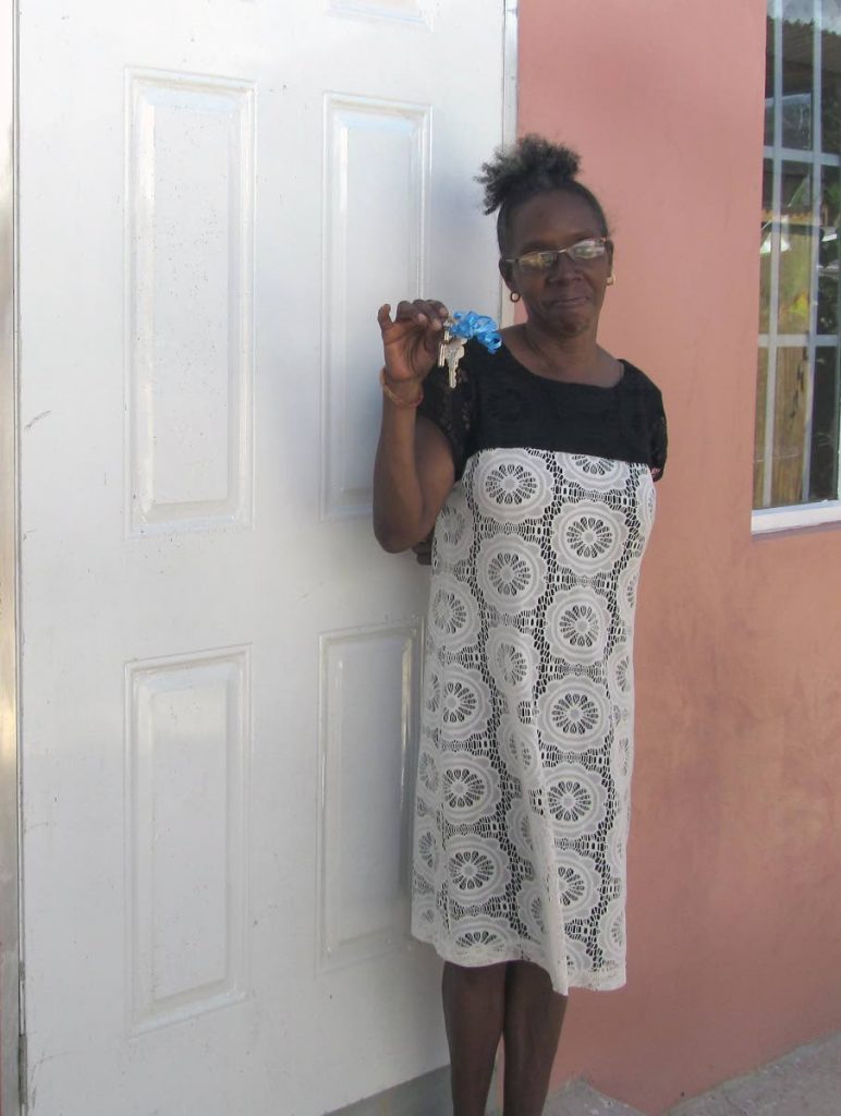 Giselle Waithe displays the keys to her new home, built for her by Habitat for Humanity, at Victory Gardens, Arima.
