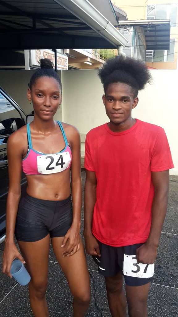 WINNERS: Kriston Charles, right, and Aaliyah Mitchell, left, pose after winning the male and female categories of the 1st annual Sangre Grande Educational Institute 5K yesterday. PHOTO BY STEPHON NICHOLAS