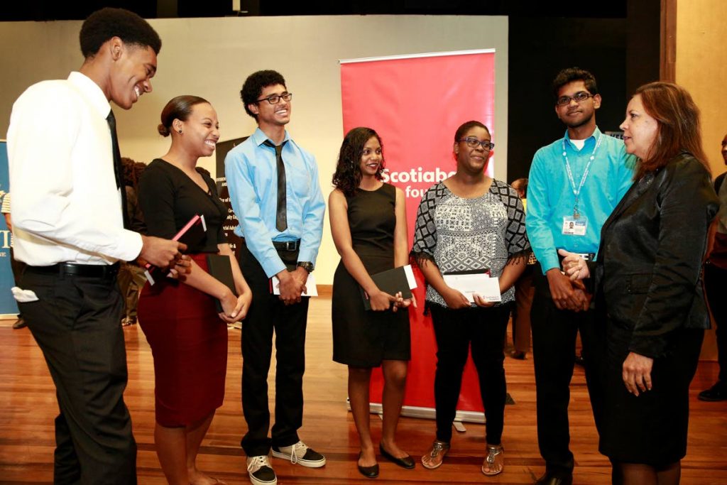 Cheryl Hernandez, Scotiabank Foundation Support Officer, right, shares a light moment with the recipients of the Scotiabank bursaries 2017.