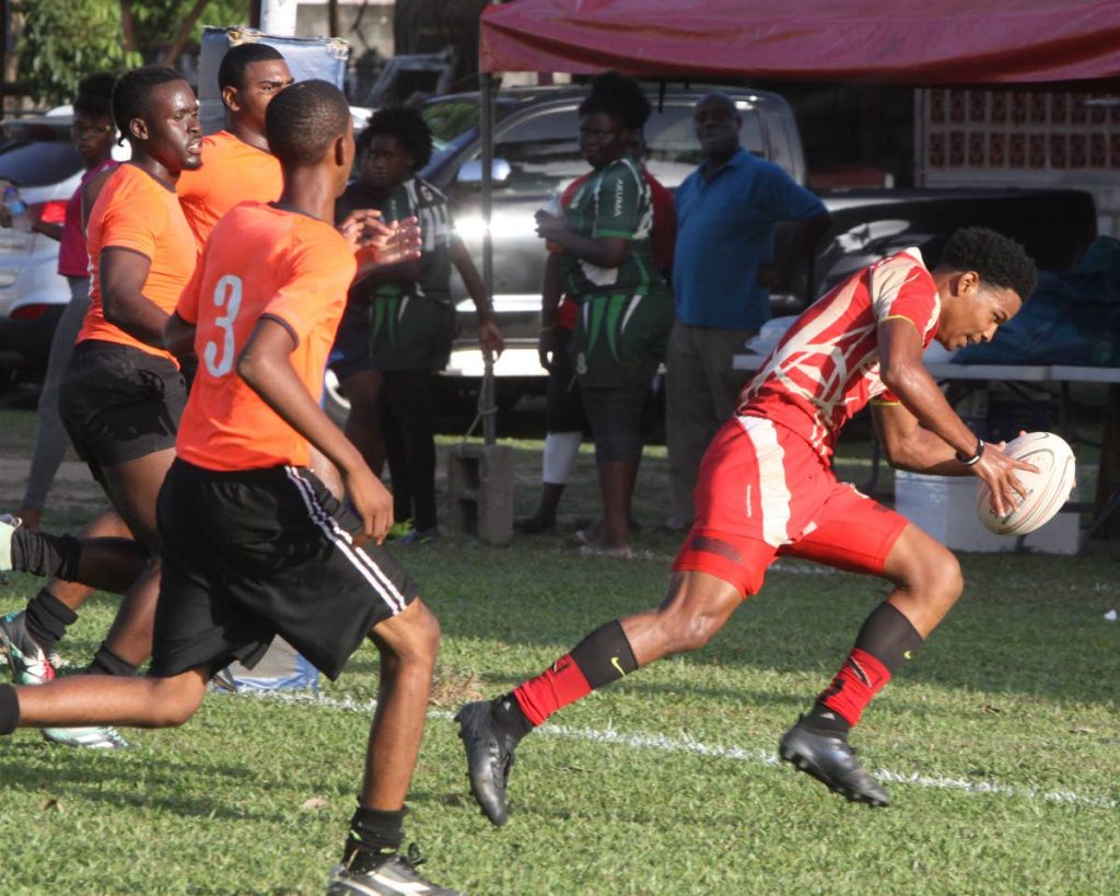 An Exiles player scores a try against Rydeus in the Boys Under-19 final at the Harvard Heineken Rugby Sevens Festival yesterday at St Mary’s Ground, St Clair.