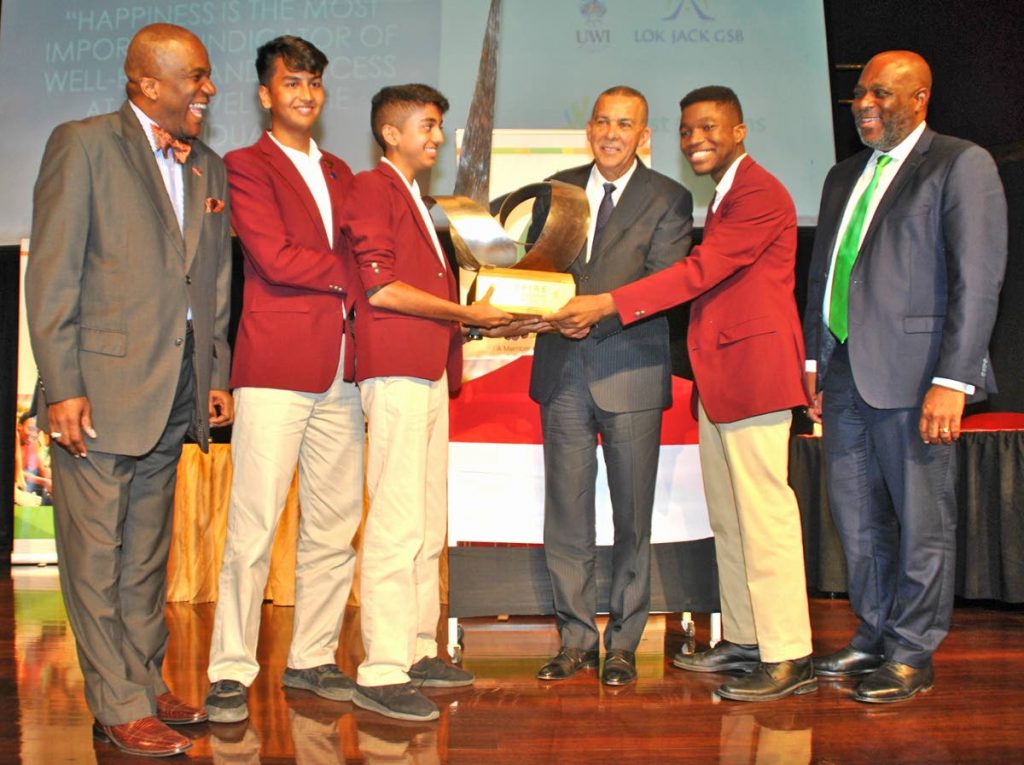 President Anthony Carmona (third from right) presents the Junior Achievement Leadership Debate Series Challenge Trophy to Presentation Chaguanas students (from left) Tej Capildeo, Jerod Griffith and Kabir Singh. Sharing in the occasion are J. Errol Lewis, JA Executive Director; and JA Chairman Anthony Pierre.