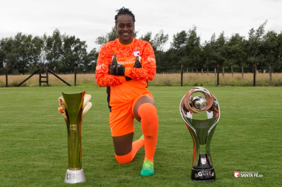 Kimika Forbes poses with trophies won by her Colombian club Independiente Santa Fe.