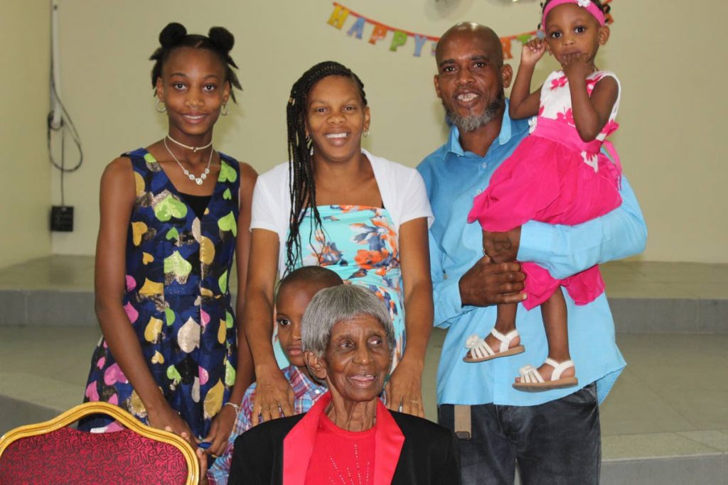 Granny Luces, front, celebrates her 90th birthday with family at Roslyn Hall, Auzonville Road, Tunapuna, Sunday.