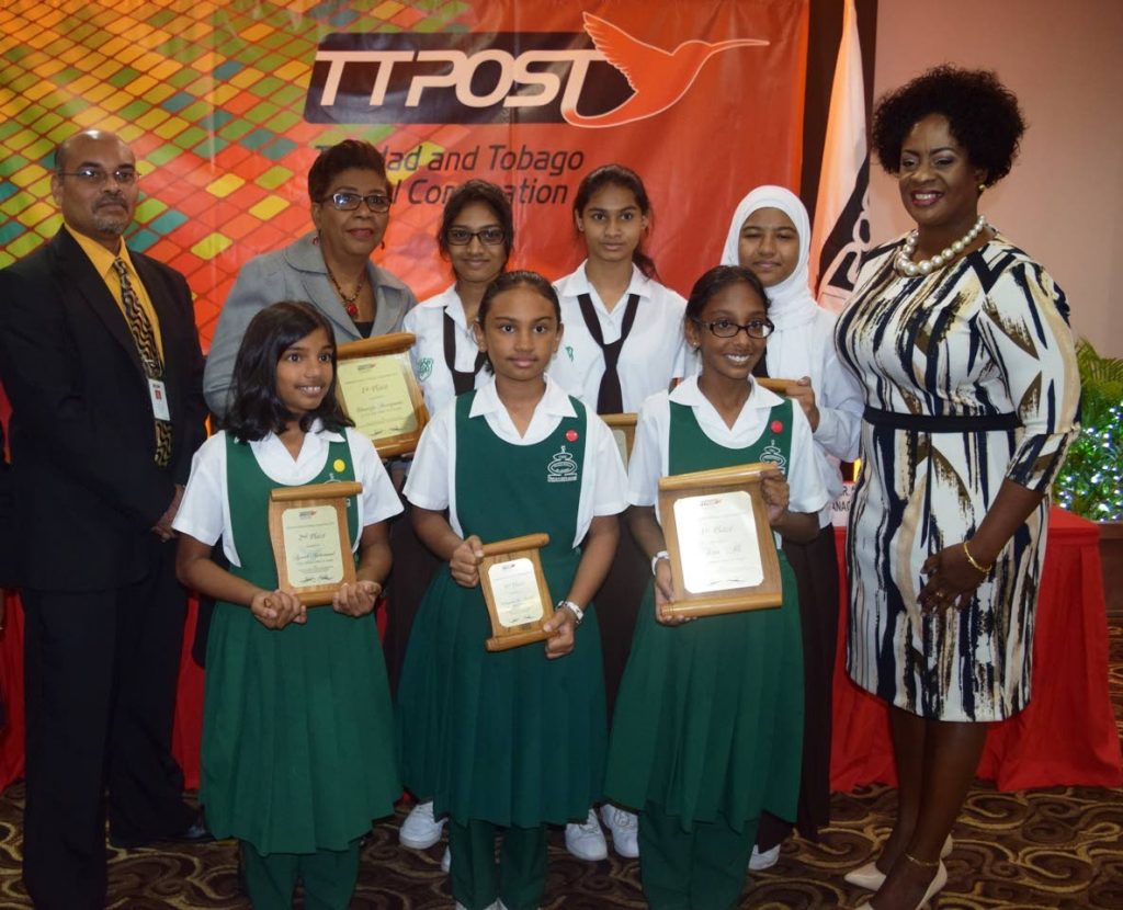 George Alexis, TTPost managing director (Ag), left; Eula Rogers, chairman of the TTPost board and Averline Scott,  of the Ministry of Public Utilities with the winners of the TTPost National Letter Writing competition.