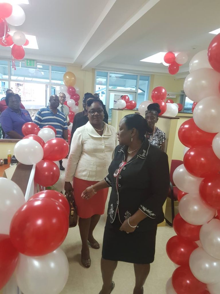Glenda Carew, Head of Tobago Operation, National Entrepreneurship Development Company (NEDCO), takes attendees on a tour of the office during an Open House last Thursday.
