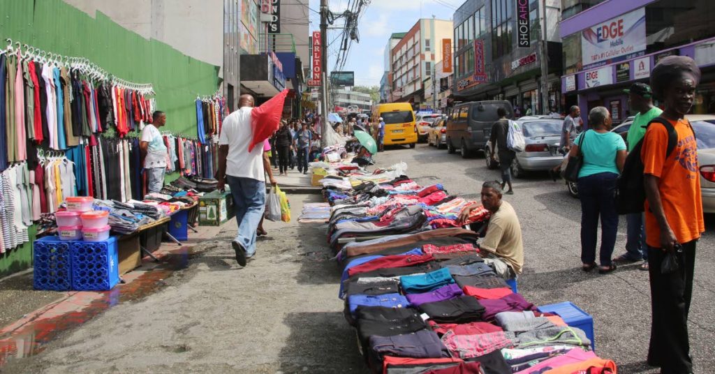 Vendors ply their trade along High Street, San Fernando yesterday.