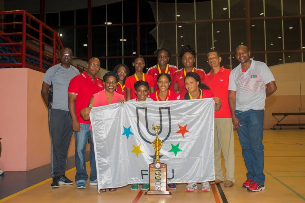 UTT netballers and management team pose with the tertiary sports trophy after beating UWI in the final recently at UWI-SPEC, St Augustine.