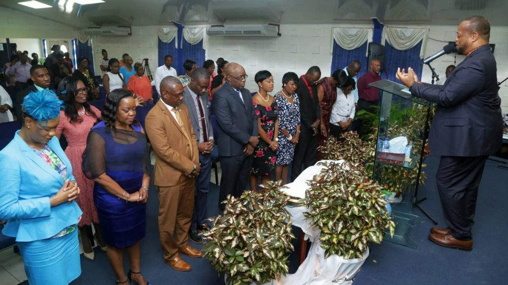 Pastor Cuthbert Gordon, right, offers prayers at a thanksgiving service on Sunday, marking the start of Tobago Day 2017 celebrations, at the Church of the Nazarene, Canaan. The event was attended by Member of Parliament for Tobago East, Ayanna Webster-Roy, left, Tobago House of Assemblys Chief Secretary Kelvin Charles, third from left, front row, and other Assemblymen. 