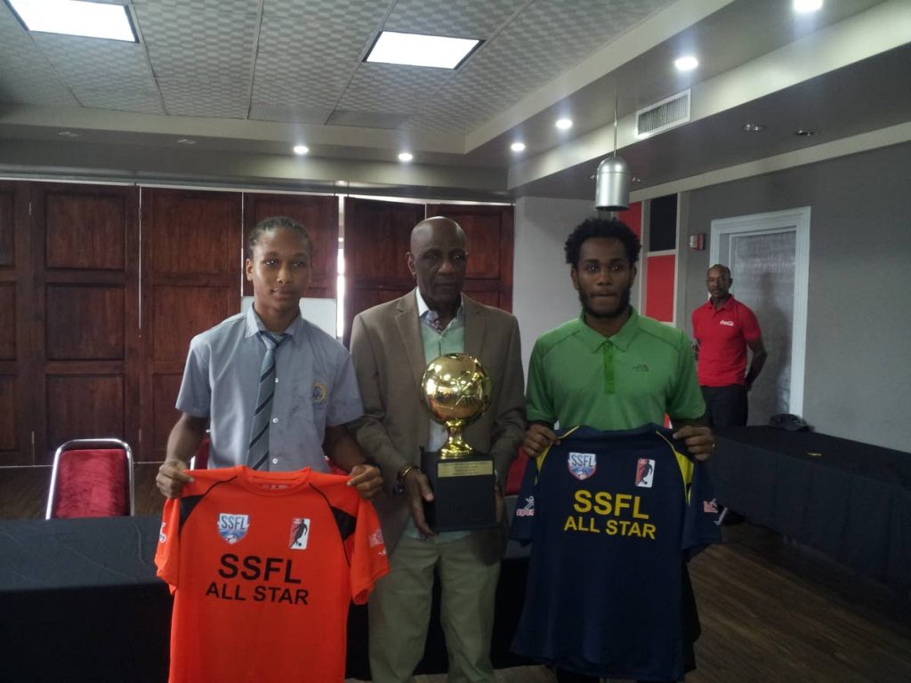 Former national player Steve David, centre, poses with the All-Star Game trophy alongside South captain Judah Garcia, left, and North skipper Matthaeus Granger at the VIP Lounge, Hasely Crawford Stadium, Mucurapo, yesterday.