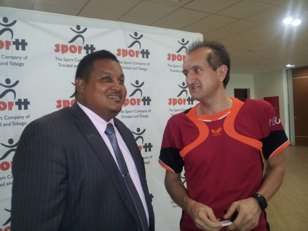 Latin America Development Officer at the International Table Tennis Federation Ramon Ortega Montes, right, in discussion with Minister of Sport and Youth Affairs Darryl Smith.