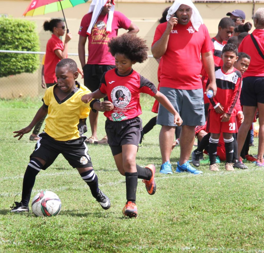 Jeremiah Daniel (left) of Brickhouse Youth Football Academy battle for the ball with Micai Deyal of Jah Soccer Lions during a match on Saturday.
