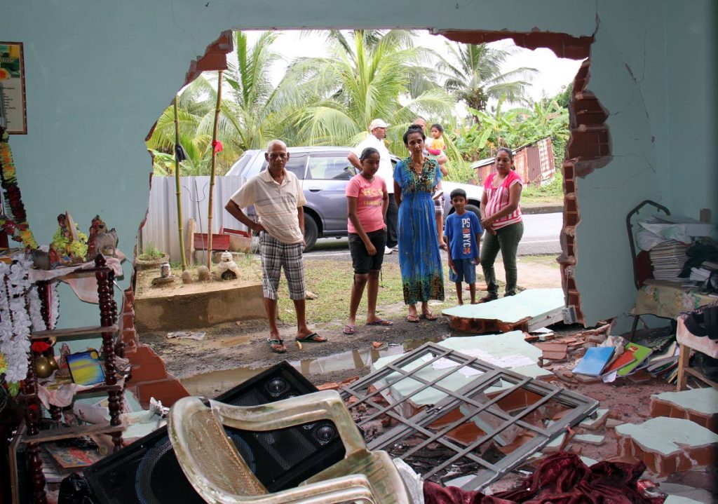 Open house: In this December 10 file photo, Vijanti Seudath and tenants look at the damage done to her home after a drunk driver crashed into the house at Wellington Road, Debe. 