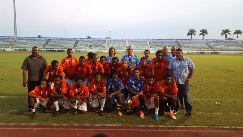 South XI footballers and management team pose with Sports Minister Darryl Smith, right, and SSFL president William Wallace, left, after winning the inaugural All-Star Game on Sunday at the Manny Ramjohn Stadium, Marabella.