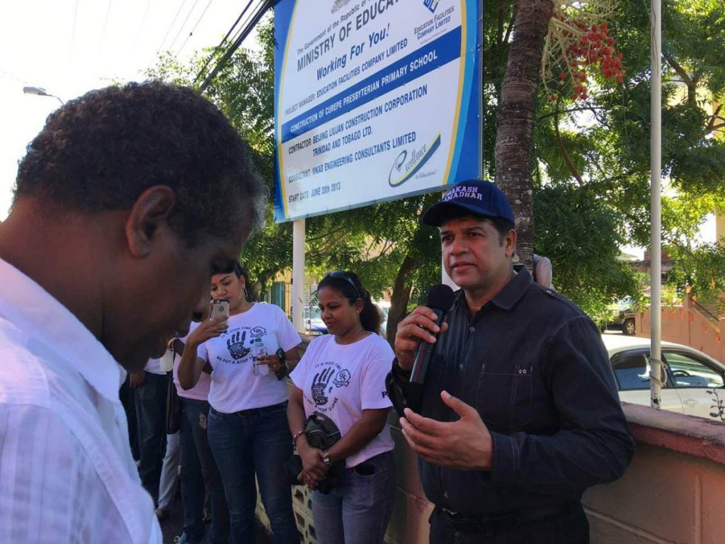 St Augustine MP Prakash Ramadhar (right) speaks during a prayer walk yesterday with the PTA of the Curepe Presbyterian School.
