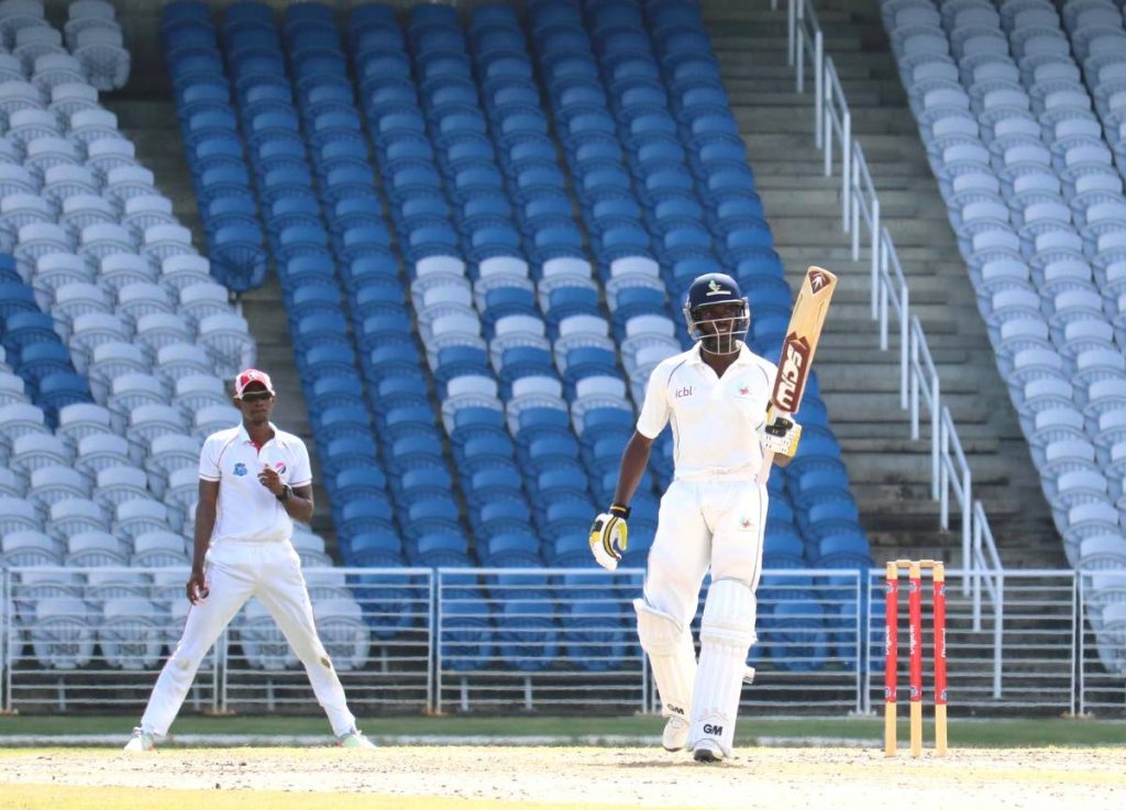 Barbados Pride batsman Jonathan Carter raises his bat after scoring a half-century yesterday vs the Red Force at the Brian Lara Academy, Tarouba.