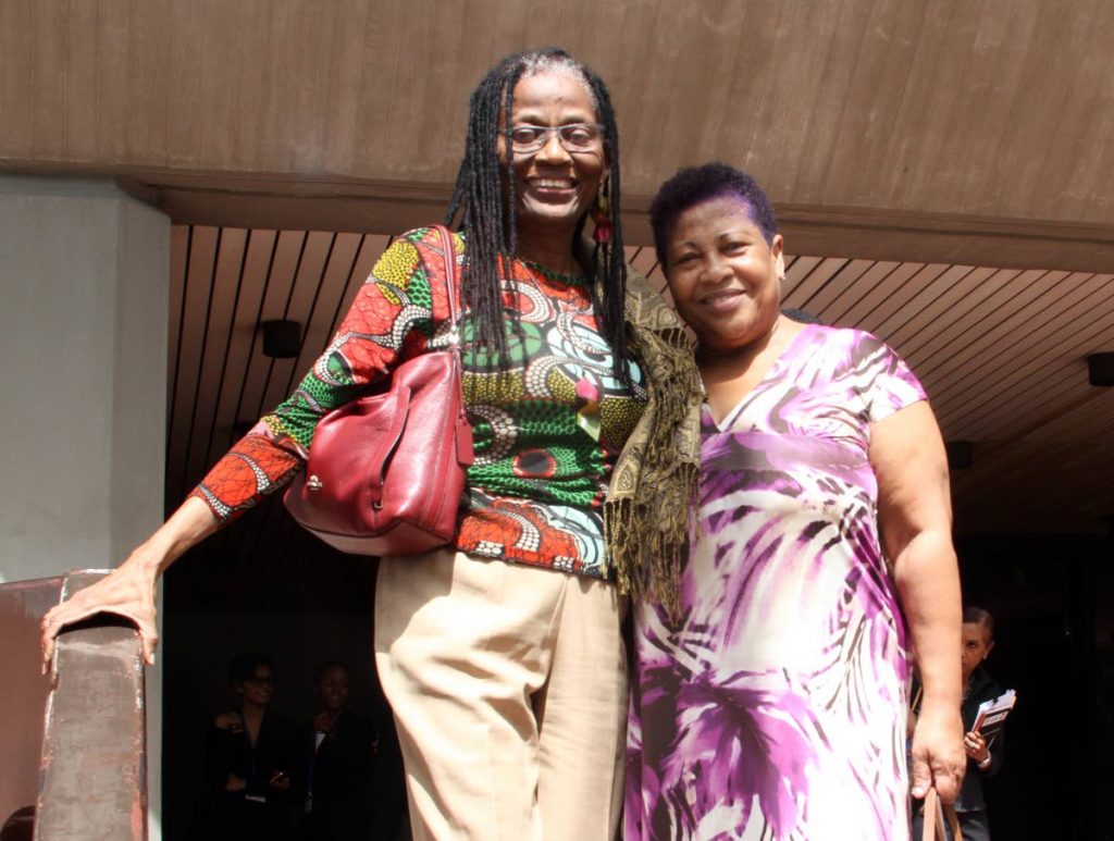 Elizabeth Montano, mother of Machel Montano, left, and Valerie Green, Kernal Roberts’ mother, leave the Hall of Justice  in Port of Spain after signing the necessary documents for their sons’ bail.