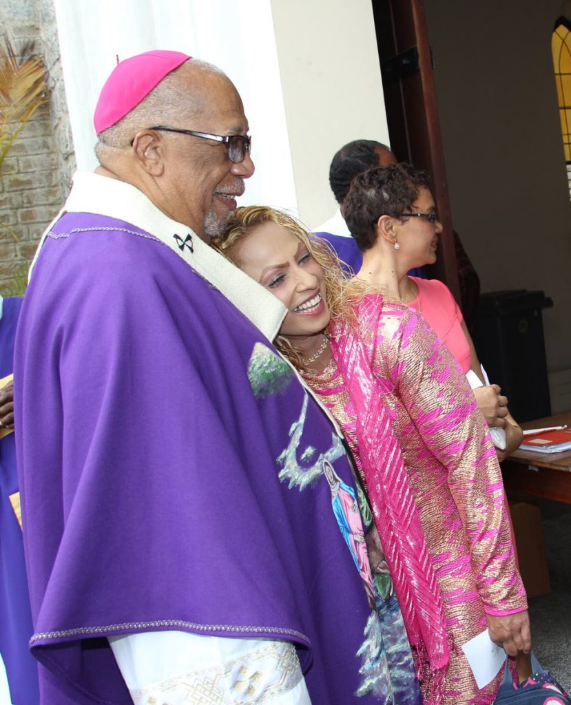 FAREWELL HUG: Outgoing Archbishop of Port of Spain Fr Joseph Harris gets a farewell huh from a parishioner after Mass yesterday at the Cathedral of the Immaculate Conception in Port of Spain. PHOTO BY RATTAN JADOO