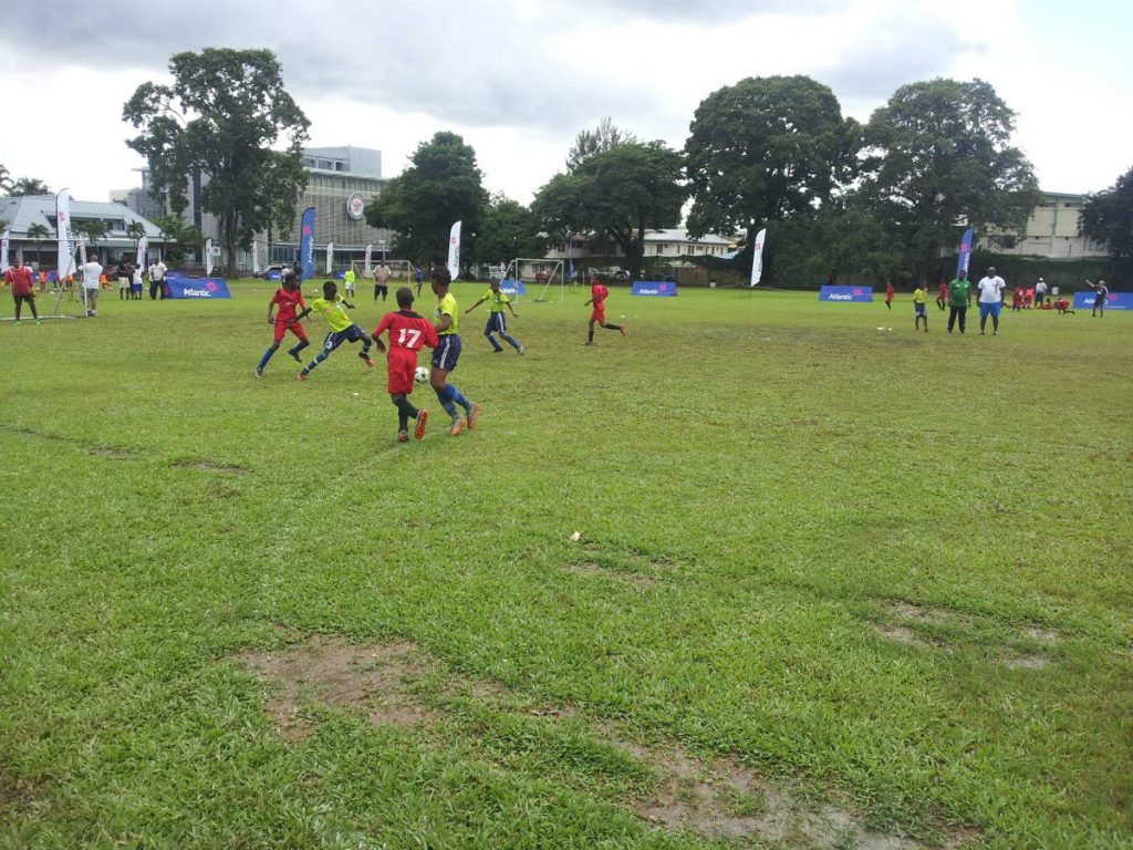 Participants battle in a match during the Atlantic Football Weekend at the Queen’s Royal College Ground in St Clair, yesterday.
