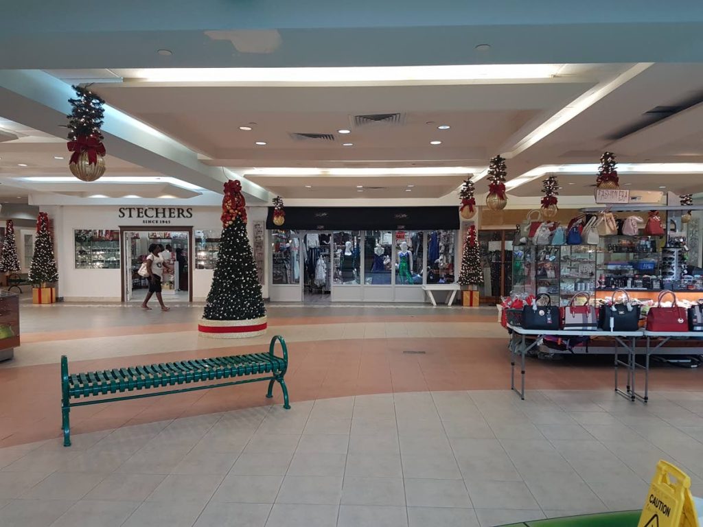 In the distance, a shopper walks along mostly empty corridors, and shops, of the Gulf City Mall on Saturday at midday.