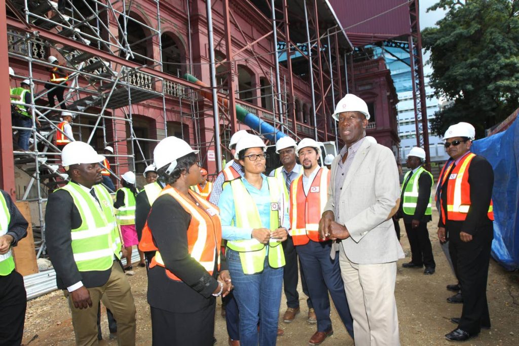 PLEASED: Prime Minister Dr Keith Rowley, Minister in the Office of the Prime Minister Stuart Young, Planning and Development Minister Camille Robinson-Regis and officials of UDeCOTT during the tour of the Red House yesterday.