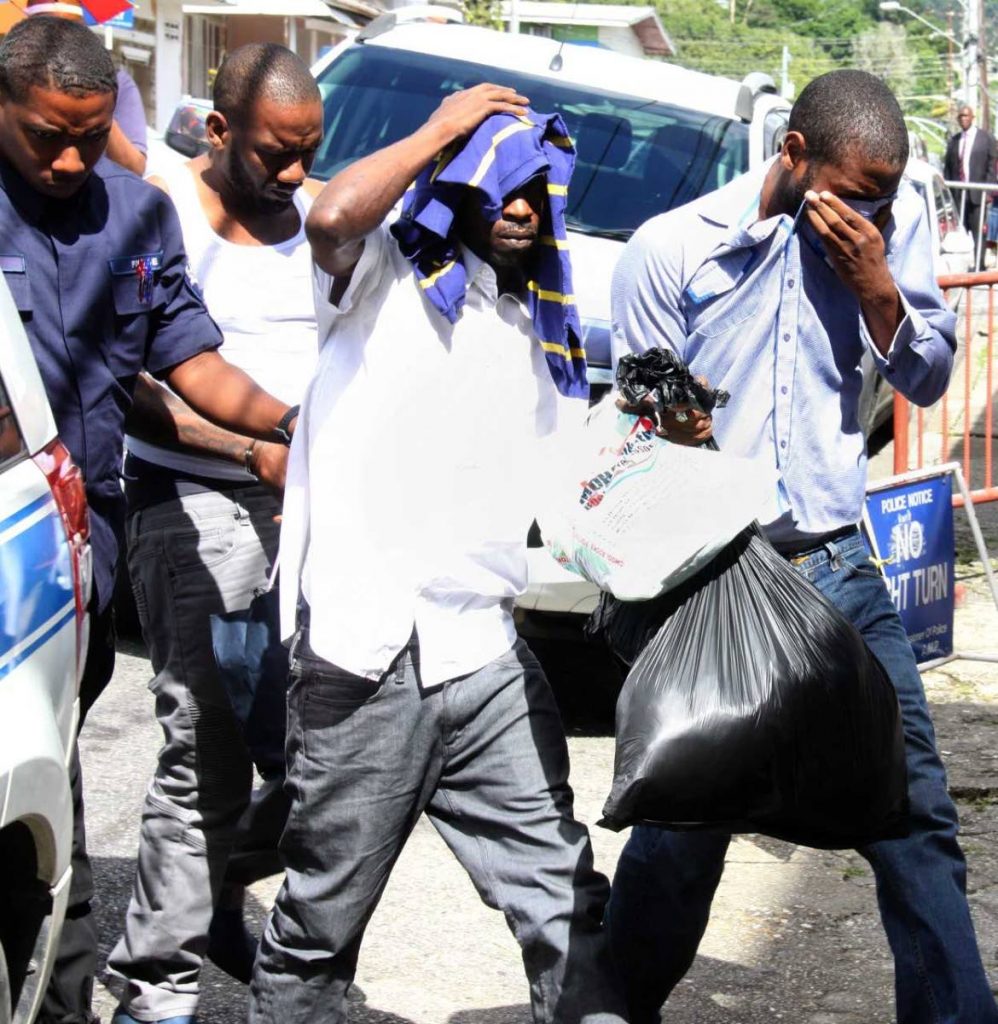 OFF TO COURT: (From left to right) Kevin Findley, Abdul Mohammed and Kenol Singh are taken to the Arima Magistrates’ Court yesterday charged in connection with the $5 million robbery at the Piarco airport on December 6.    PHOTO BY ANGELO M MARCELLE