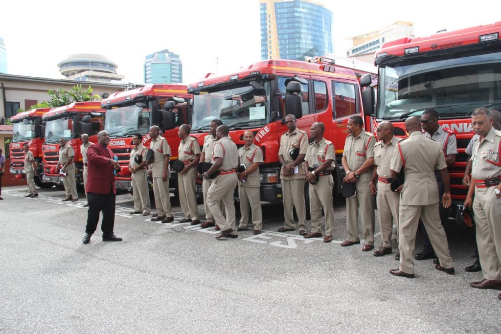 NEW RIDES: Firemen stand in front some of the new fire tenders handed over yesterday at Fire Headquarters on Wrightson Road in Port of Spain. PHOTO BY SUREASH CHOLAI