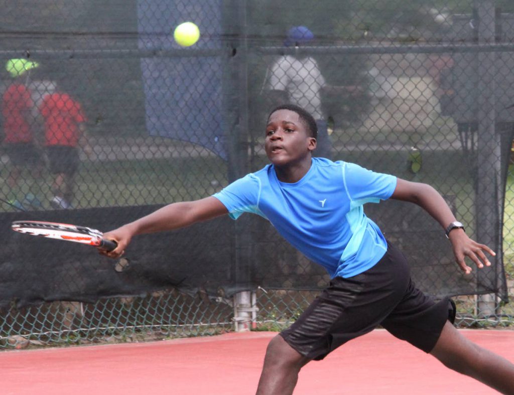 Shae Millington stretches to hit a return in the RBC Junior 
Tennis 
Tournament at the Trinidad Country Club, Maraval.