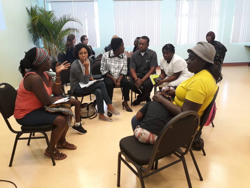 A group of parents engage in discussions at a workshop on developmental challenges children held at the Scarborough General Hospital last Friday.
