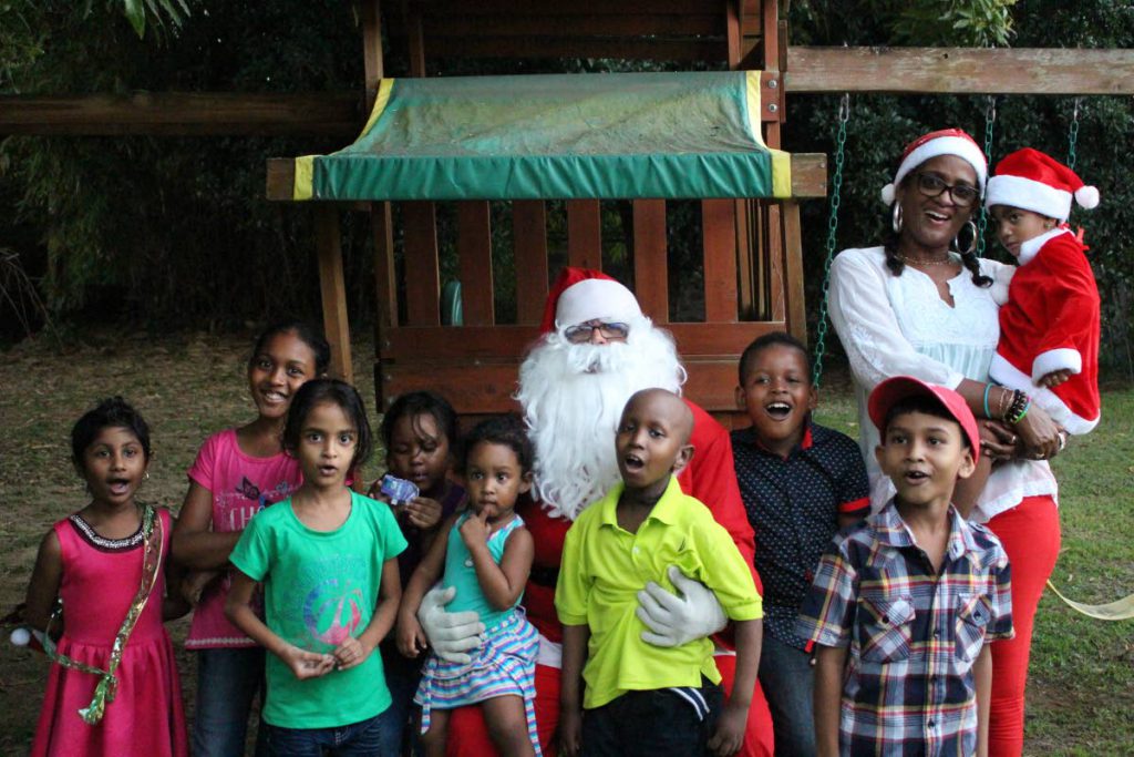 Santa takes a photo op with the JBF kids and founder Chevaughn Joseph.