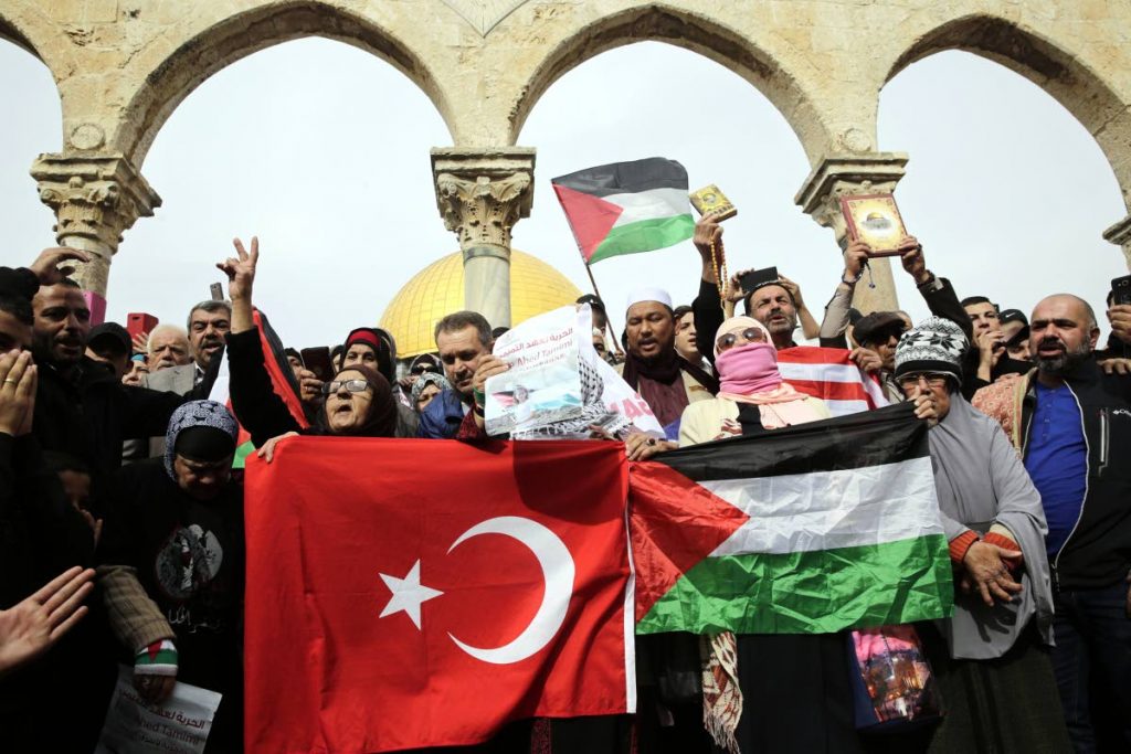 It’s our city: Palestinians chant slogans and hold flags during a demonstration at the Dome of the Rock Mosque in the Al Aqsa Mosque compound in Jerusalem’s old city last Friday. AP Photo