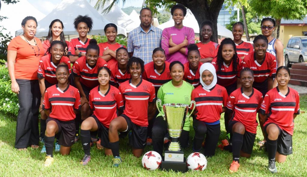 TITLE-HOLDERS: Victorious Bishop Anstey High School, Port of Spain, Girls’ football team with the Coca-Cola National Girls’ Intercol trophy