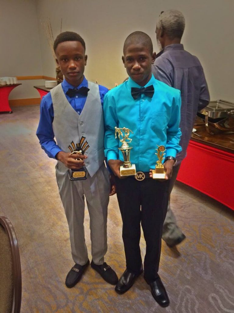 Meshac Carrington and Anthony Mohammed pose with their trophies at the Crown Trace FC Awards held at the Hyatt, recently.